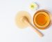 Delicious honey with wooden honey dipper on white backgroud