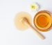 Delicious honey with wooden honey dipper on white backgroud